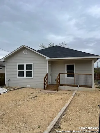 a house that has a tree in front of it