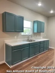 a kitchen with a refrigerator stove and a sink