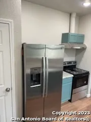 a kitchen with a sink and refrigerator