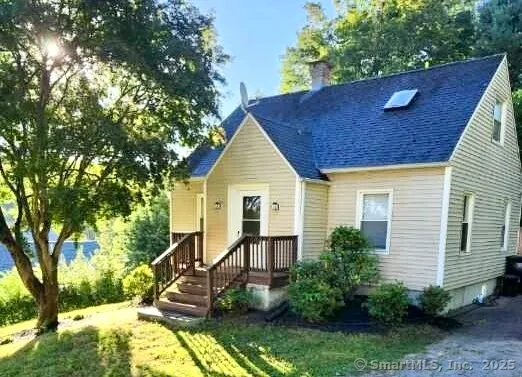a view of house with a yard