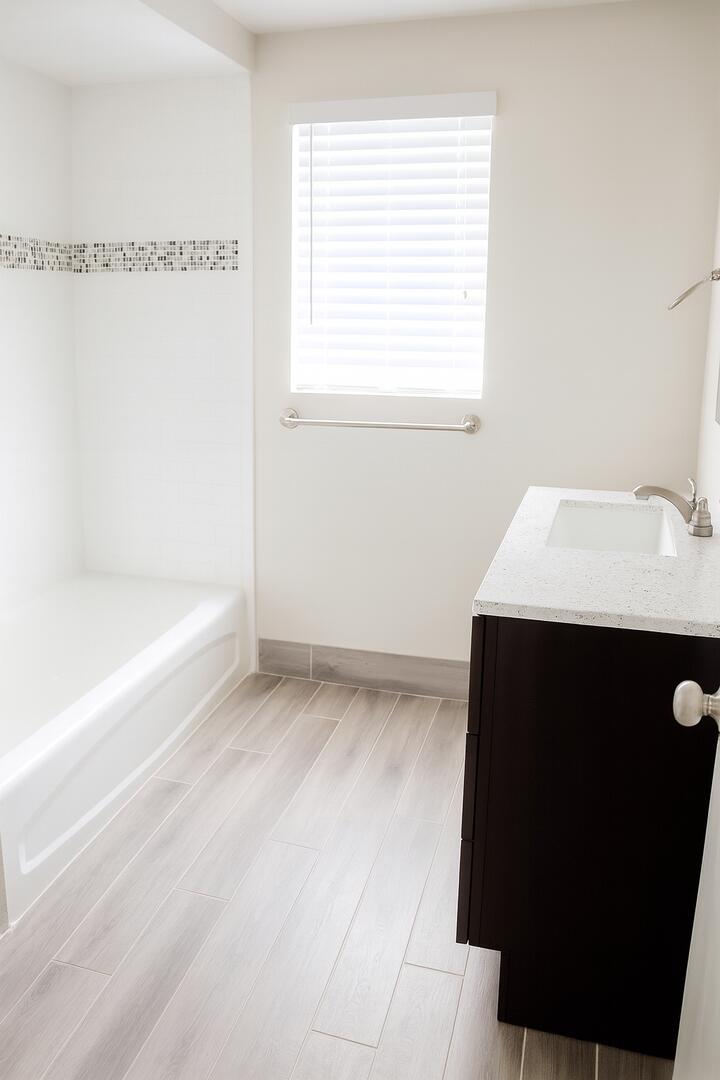 480 West Camino Real, Unit 24 Boca Raton, FL 33432 - Photo 7 of 13 a bathroom with a sink and a bathtub