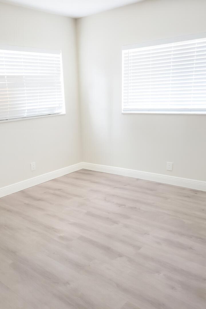 480 West Camino Real, Unit 24 Boca Raton, FL 33432 - Photo 9 of 13 an empty room with wooden floor and a window