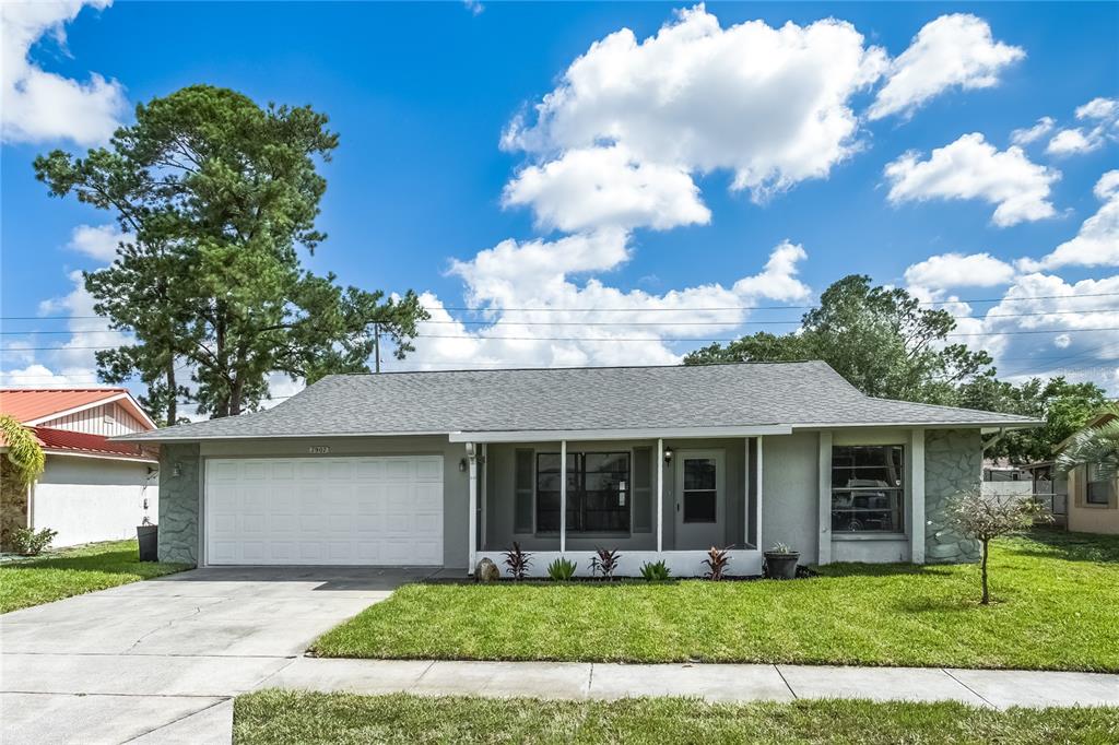 7907 Deer Foot Drive New Port Richey, FL 34653 - Photo 1 of 1 a front view of a house with garden