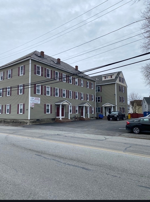 341 Lakeview Avenue, Unit 9 Lowell, MA 01850 - Photo 1 of 8 a black car parked in front of a building