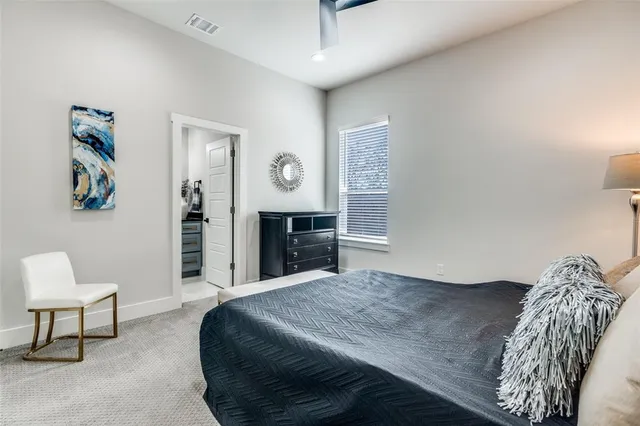 a bedroom with a bed and a chair