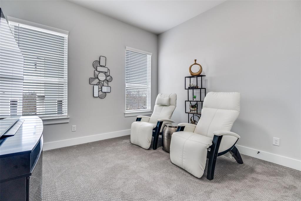 518 Crete Street Dallas, TX 75203 - Photo 18 of 27 Upstairs bedroom (used as a Media room) featuring carpet flooring