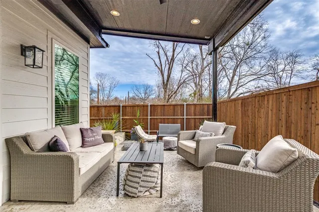 a balcony with furniture and a large window