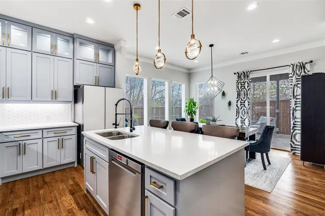 a kitchen with stainless steel appliances a table chairs and a chandelier