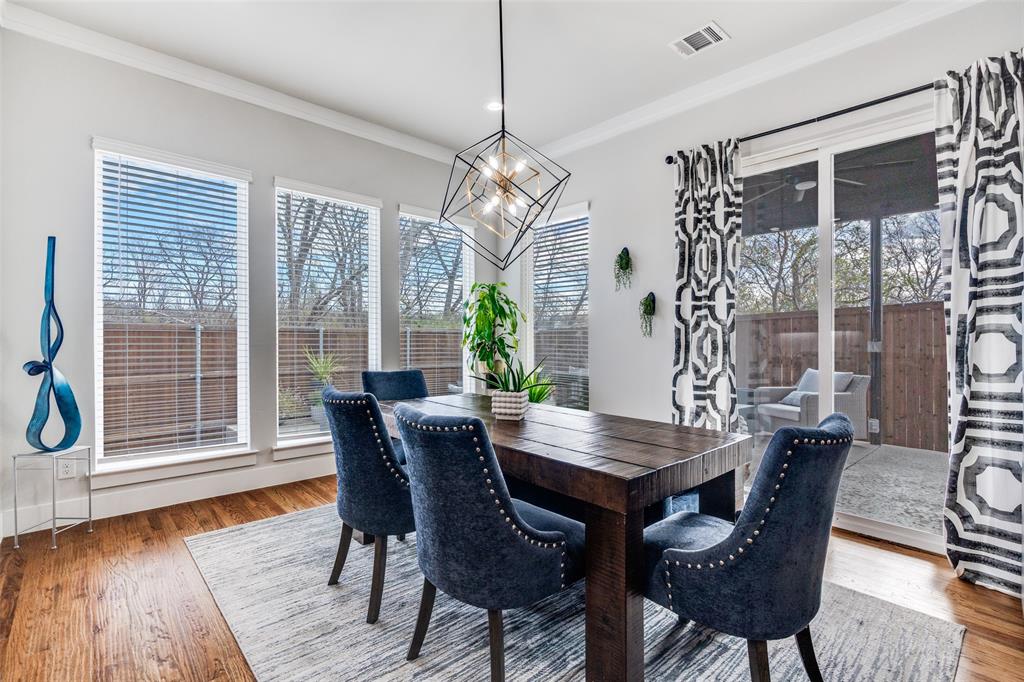 518 Crete Street Dallas, TX 75203 - Photo 8 of 27 Dining room featuring wood finished floors, ornamental molding, and healthy amount of natural light