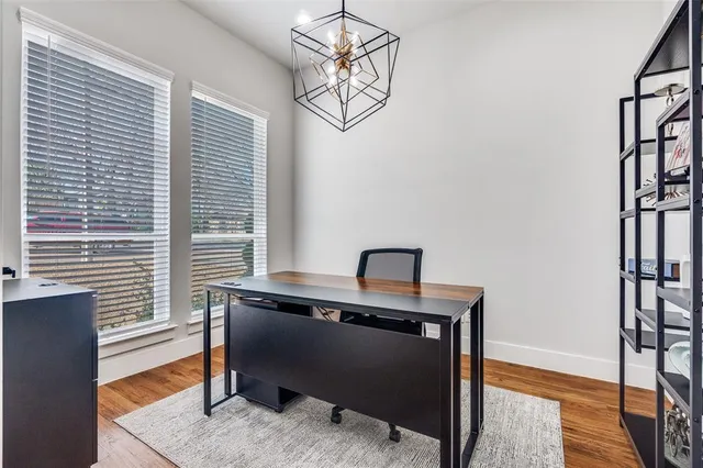 a view of a workspace with furniture and a window