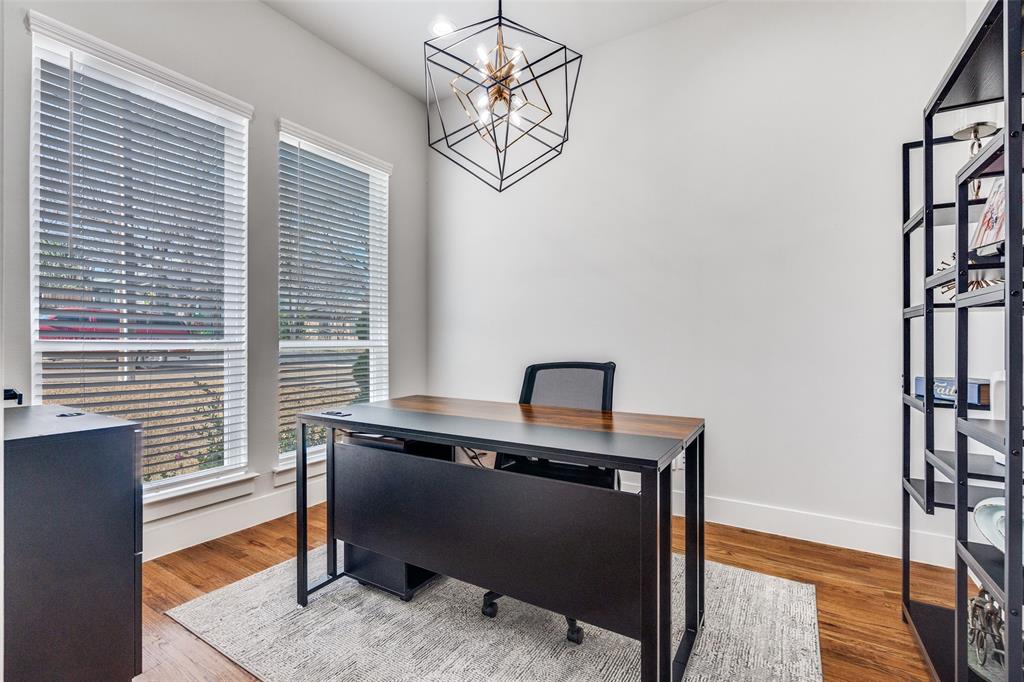 518 Crete Street Dallas, TX 75203 - Photo 10 of 27 Bedroom downstairs (used as office) featuring wood floors and a chandelier