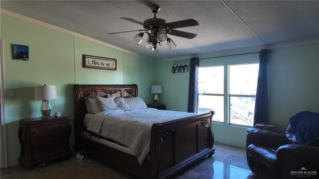 a bedroom with a bed and a couch