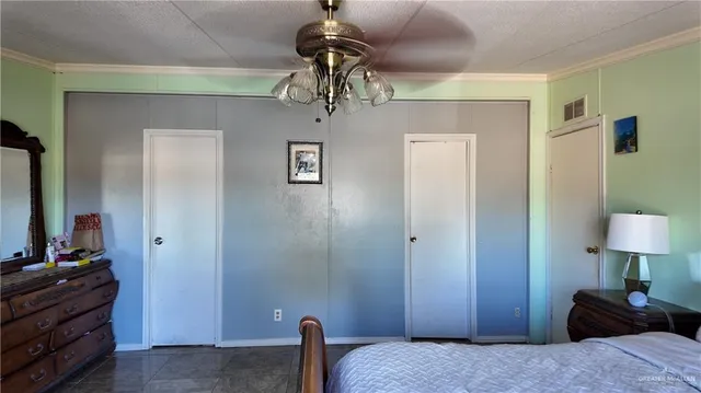 a bedroom with a bed and a mirror