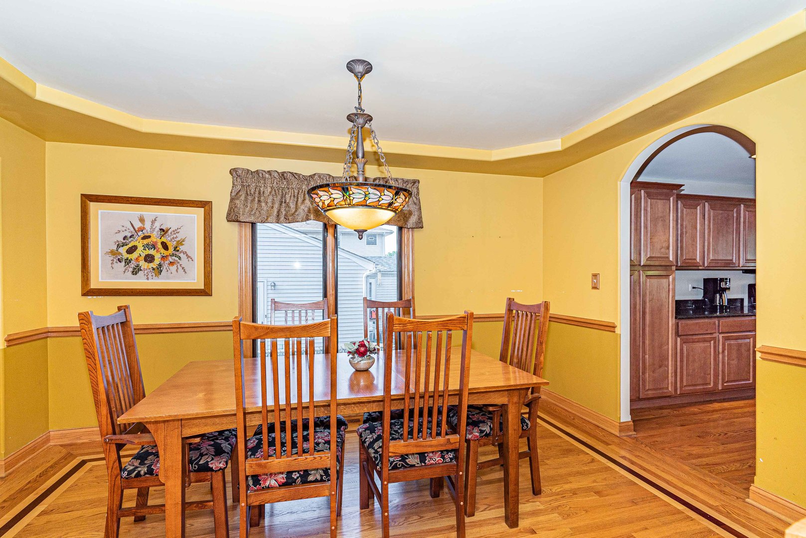 10551 Princess Avenue Chicago Ridge, IL 60415 - Photo 4 of 26 a dining room with furniture a chandelier and wooden floor