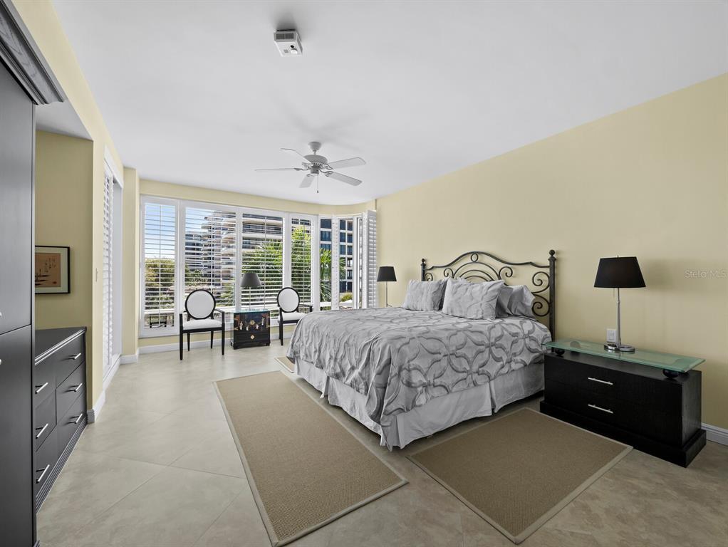 455 Longboat Club Road, Unit 402 Longboat Key, FL 34228 - Photo 16 of 50 a bedroom with a bed and a view of balcony