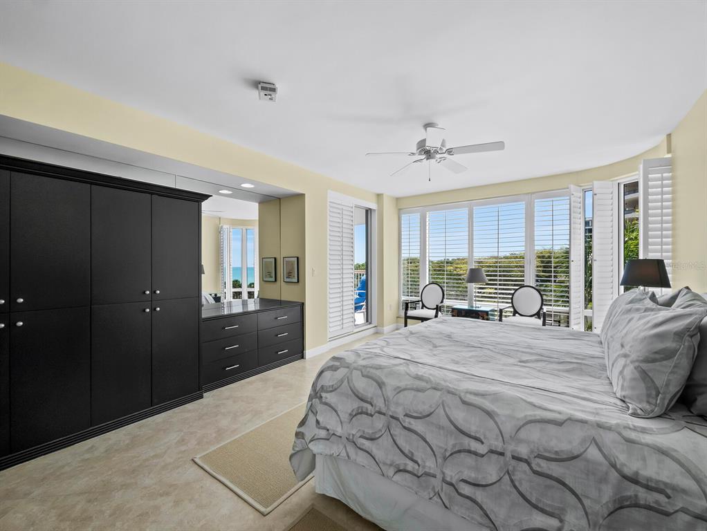 455 Longboat Club Road, Unit 402 Longboat Key, FL 34228 - Photo 17 of 50 a bedroom with a bed and a large window
