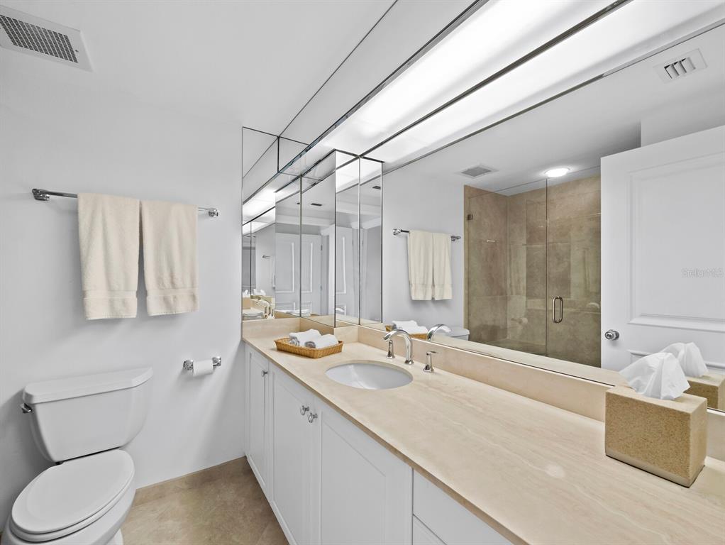 455 Longboat Club Road, Unit 402 Longboat Key, FL 34228 - Photo 22 of 50 a bathroom with a sink double vanity granite and a toilet