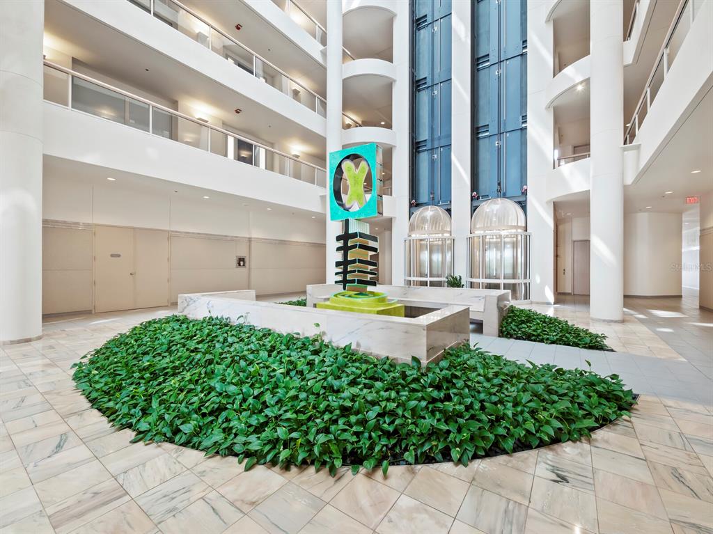 455 Longboat Club Road, Unit 402 Longboat Key, FL 34228 - Photo 31 of 50 a front view of a building with a garden