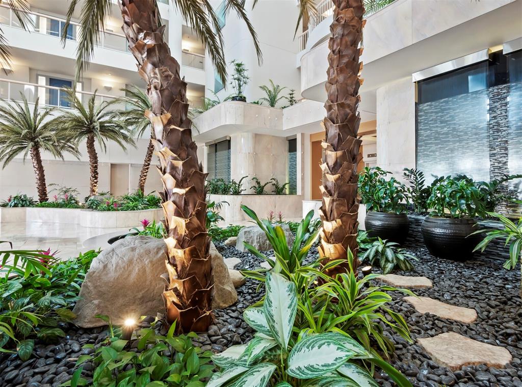 455 Longboat Club Road, Unit 402 Longboat Key, FL 34228 - Photo 32 of 50 a front view of a house with a garden