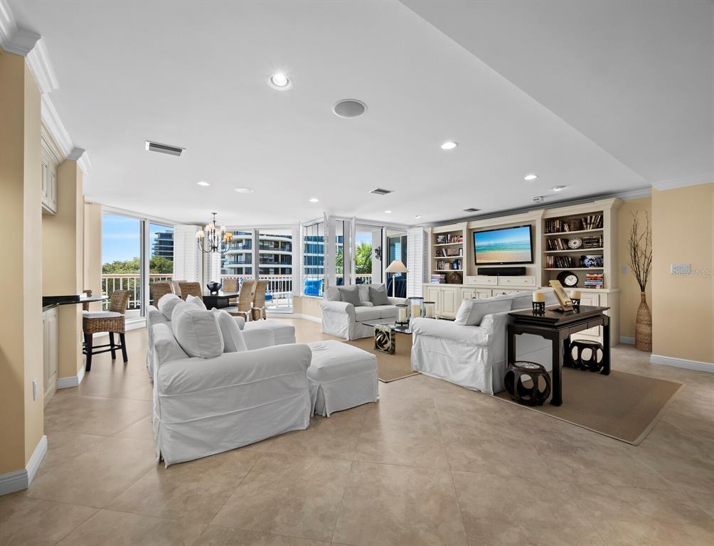 455 Longboat Club Road, Unit 402 Longboat Key, FL 34228 - Photo 4 of 50 a living room with furniture and a flat screen tv