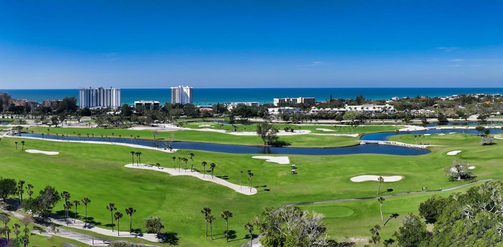 455 Longboat Club Road, Unit 402 Longboat Key, FL 34228 - Photo 47 of 50 a view of a golf course with a building in the background