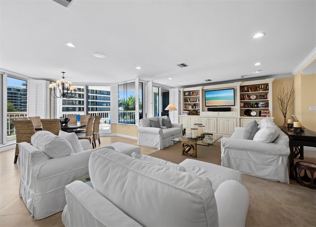 455 Longboat Club Road, Unit 402 Longboat Key, FL 34228 - Photo 5 of 50 a living room with furniture fireplace and flat screen tv