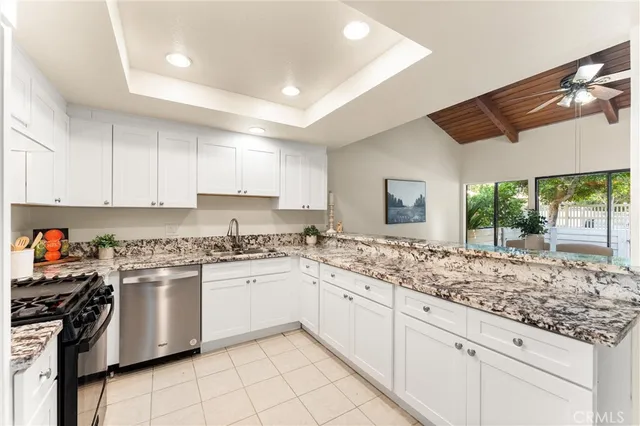 a kitchen with a stove sink and cabinets