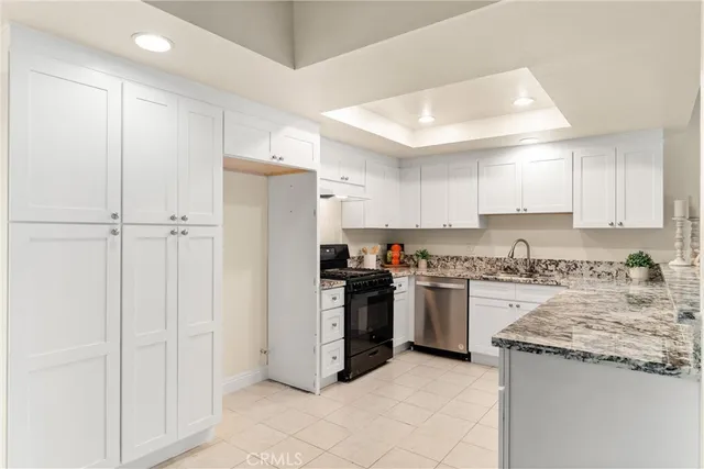a kitchen with a stove a refrigerator and a sink
