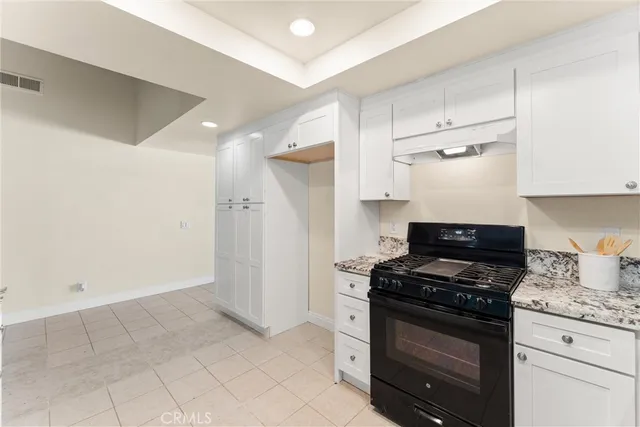 a kitchen with stainless steel appliances a stove a microwave and a refrigerator