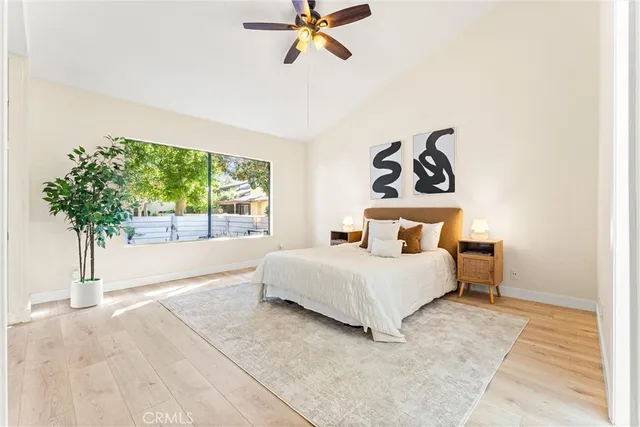 a bedroom with a bed and a plant