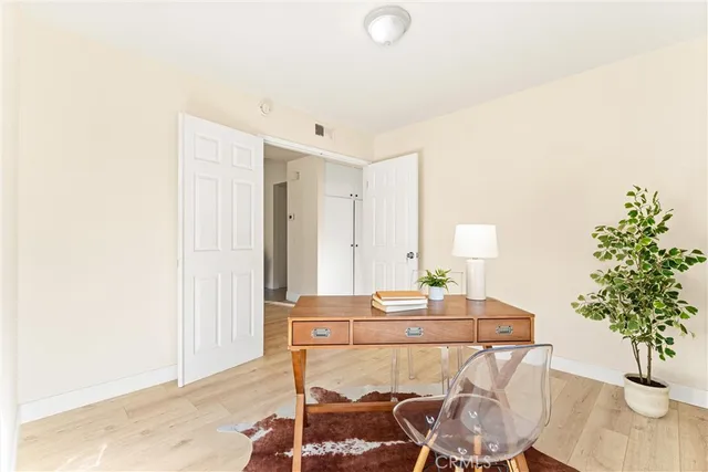 a workspace with furniture and a potted plant