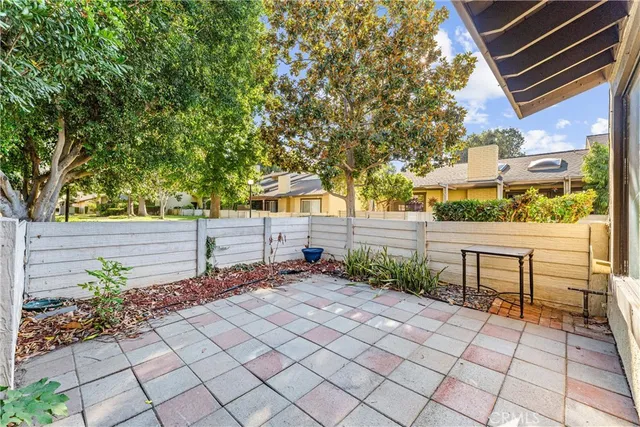 a view of a chairs and bench in a yard
