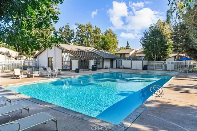 a view of a house with swimming pool and sitting area