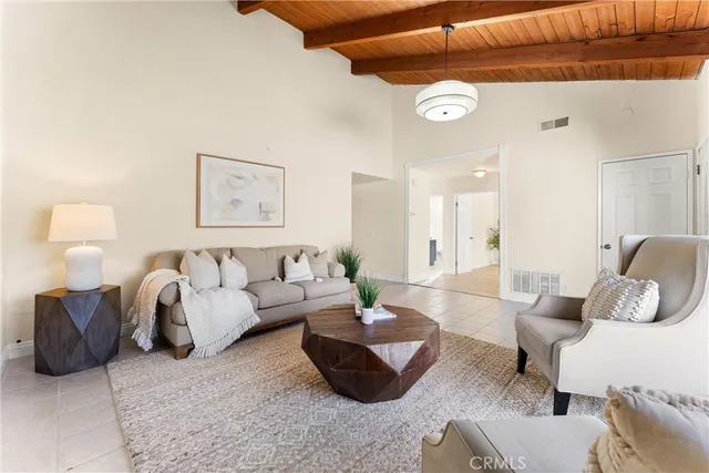 a large white kitchen with a fireplace and a large window