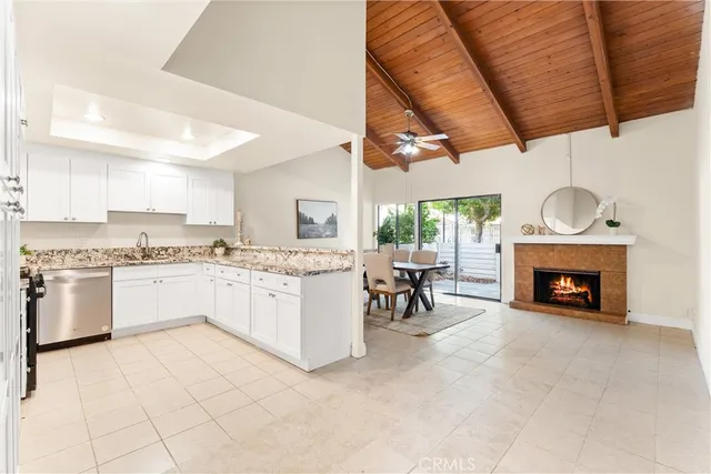 a dining room with furniture a fireplace and wooden floor