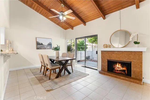a dining room with furniture a fireplace and wooden floor