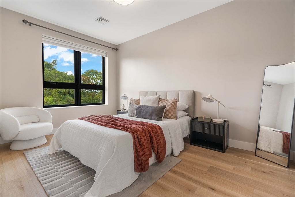 70 Leo M Birmingham Parkway, Unit U307 Boston, MA 02135 - Photo 11 of 35 a bedroom with bed and a large window