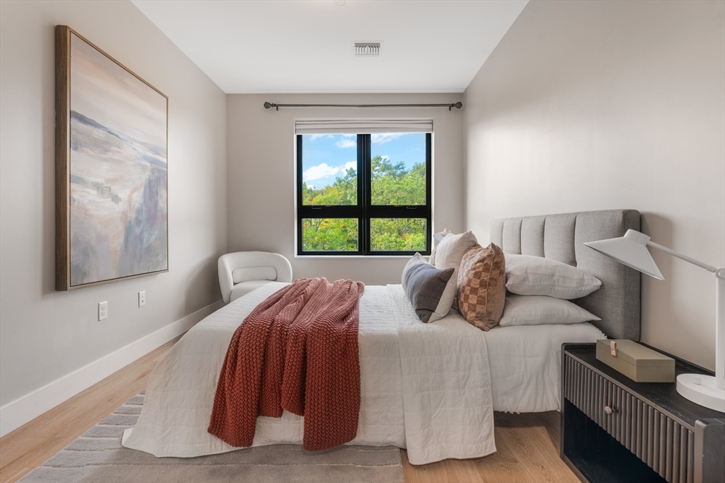 70 Leo M Birmingham Parkway, Unit U307 Boston, MA 02135 - Photo 12 of 35 a bedroom with a bed and a window