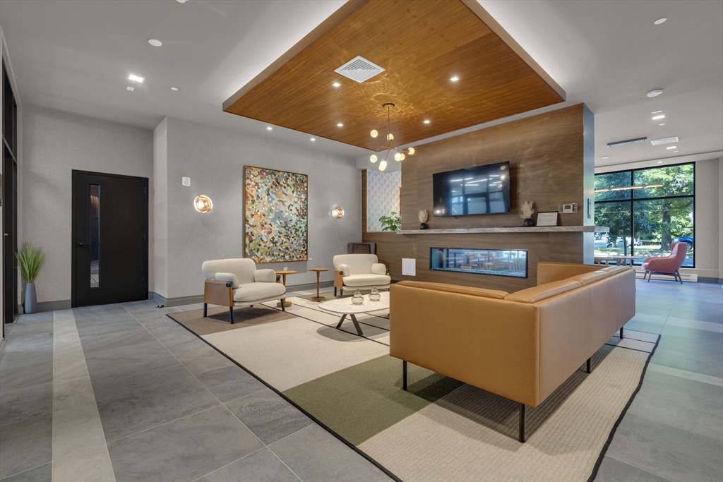 70 Leo M Birmingham Parkway, Unit U307 Boston, MA 02135 - Photo 18 of 35 a living room with furniture and a flat screen tv