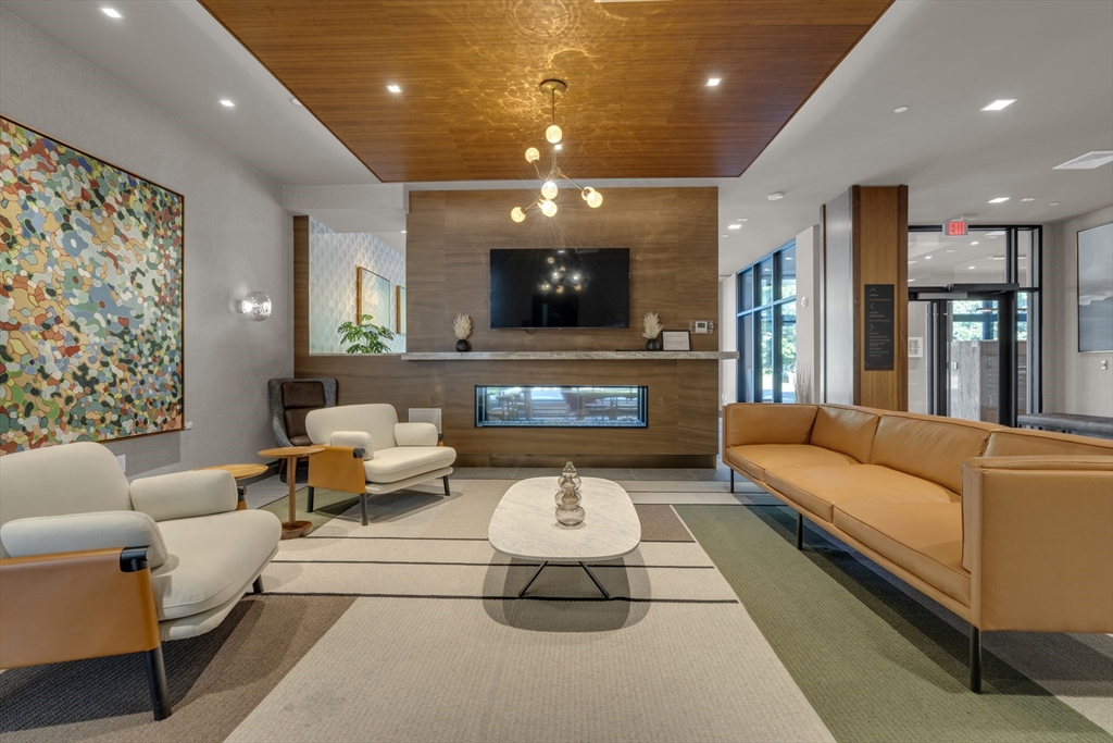 70 Leo M Birmingham Parkway, Unit U307 Boston, MA 02135 - Photo 19 of 35 a living room with furniture and a flat screen tv