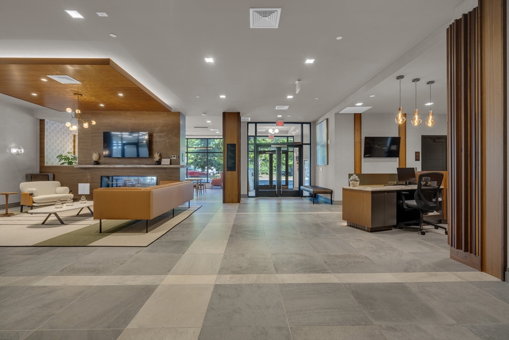 70 Leo M Birmingham Parkway, Unit U307 Boston, MA 02135 - Photo 20 of 35 a lobby with furniture and view of kitchen