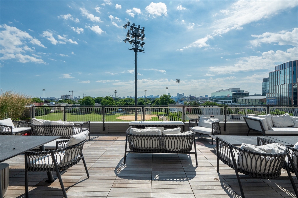 70 Leo M Birmingham Parkway, Unit U307 Boston, MA 02135 - Photo 22 of 35 a view of a patio with couches and pool