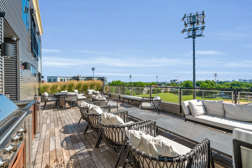 70 Leo M Birmingham Parkway, Unit U307 Boston, MA 02135 - Photo 23 of 35 a roof deck with couches and potted plants