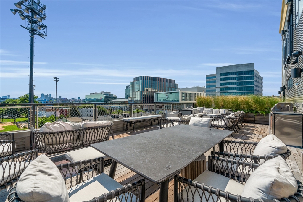 70 Leo M Birmingham Parkway, Unit U307 Boston, MA 02135 - Photo 24 of 35 a terrace with outdoor seating and city view