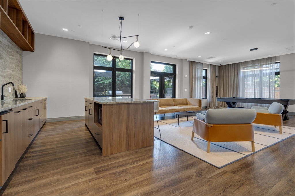 70 Leo M Birmingham Parkway, Unit U307 Boston, MA 02135 - Photo 25 of 35 a living room with stainless steel appliances granite countertop furniture a wooden floor and a sink