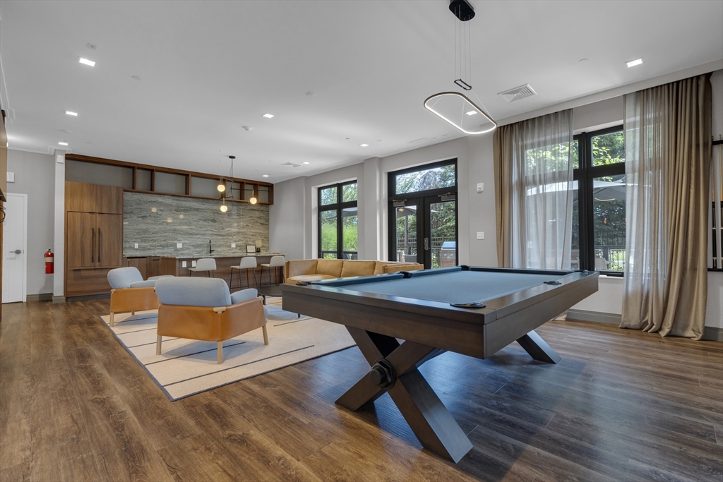 70 Leo M Birmingham Parkway, Unit U307 Boston, MA 02135 - Photo 27 of 35 a living room with furniture pool table and a large window