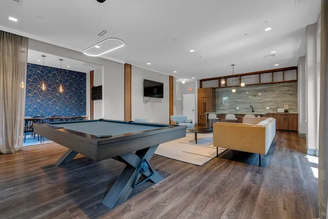 a living room with furniture a table and wooden floor