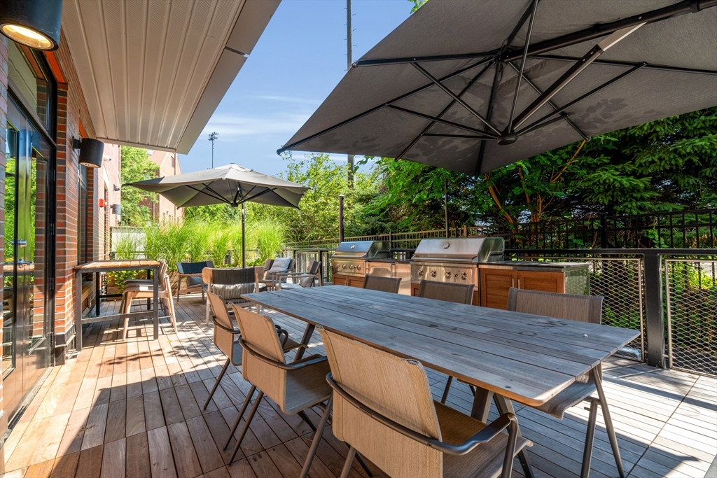 70 Leo M Birmingham Parkway, Unit U307 Boston, MA 02135 - Photo 30 of 35 a view of patio with table and chairs under an umbrella