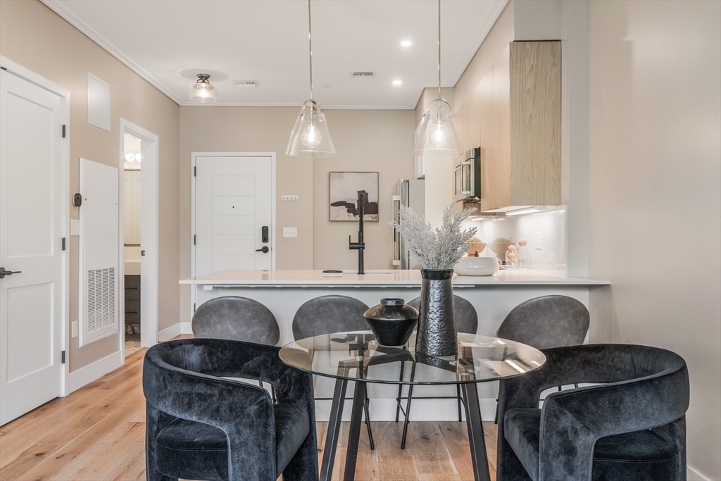 70 Leo M Birmingham Parkway, Unit U307 Boston, MA 02135 - Photo 6 of 35 a view of kitchen with dining area and chandelier