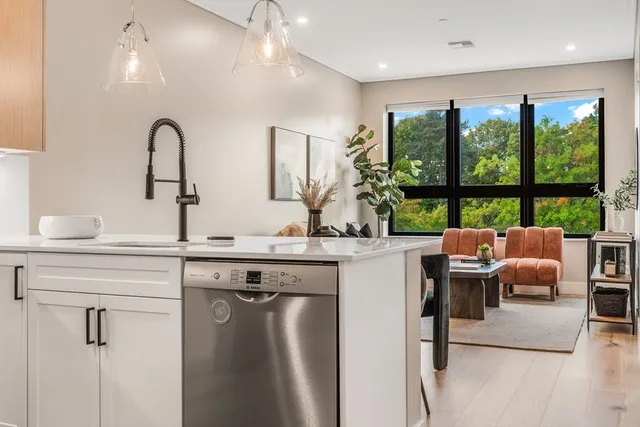 a kitchen with kitchen island a large window in it